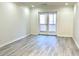 Bright living room with hardwood floors and sliding doors to a private balcony at 14 Saint Claire Ne Ln, Atlanta, GA 30324