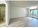 Neutral living room featuring modern gray flooring and access to the bathroom at 14 Saint Claire Ne Ln, Atlanta, GA 30324