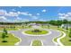 Beautiful aerial view featuring a roundabout with landscaped center and surrounding neighborhood homes and greenery at 8588 Seabiscuit Rd, Lithonia, GA 30058