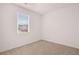 Bright bedroom with neutral carpeting and a window view at 8588 Seabiscuit Rd, Lithonia, GA 30058