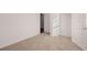 Bedroom with an open closet and neutral carpeting at 8588 Seabiscuit Rd, Lithonia, GA 30058