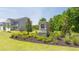 Community entrance with a stone sign, landscaping, and a two-story home in the background at 8588 Seabiscuit Rd, Lithonia, GA 30058
