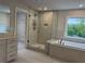 Elegant bathroom featuring a glass shower, double vanity, and soaking tub, all designed for ultimate relaxation at 1065 Low Water Nw Xing, Acworth, GA 30101