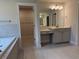 Serene bathroom featuring a bathtub, vanity with ample storage, and a walk-in closet for added convenience at 1065 Low Water Nw Xing, Acworth, GA 30101
