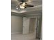 Bright bedroom with neutral carpeting, a ceiling fan, and double doors leading to a walk-in closet at 1065 Low Water Nw Xing, Acworth, GA 30101