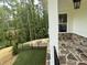 Enjoy this covered porch with stone flooring and a fire pit, perfect for relaxation at 1065 Low Water Nw Xing, Acworth, GA 30101