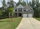 Beautiful two-story home with brick and siding, complemented by a well-manicured lawn and a two-car garage at 1065 Low Water Nw Xing, Acworth, GA 30101
