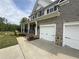 Charming home featuring a two-car garage, stone accents, and a welcoming front porch at 1065 Low Water Nw Xing, Acworth, GA 30101