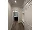 Inviting hallway featuring hardwood floors, a mudroom bench with cubbies, and access to a powder room at 1065 Low Water Nw Xing, Acworth, GA 30101