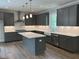 This kitchen features sleek gray cabinets, a center island with marble countertop, and stainless steel appliances at 1065 Low Water Nw Xing, Acworth, GA 30101