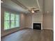Spacious living room boasts tray ceilings, a fireplace, and large windows offering natural light and wooded views at 1065 Low Water Nw Xing, Acworth, GA 30101