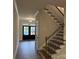 Beautiful staircase with wooden steps and black iron railings, complemented by natural light and elegant trim at 1065 Low Water Nw Xing, Acworth, GA 30101
