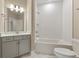 Cozy bathroom with a combination bathtub and shower, modern fixtures, and white subway tile at 5365 Maggie Mae Ln, Cumming, GA 30028
