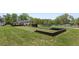 Bocce ball court surrounded by green space in a residential community at 5365 Maggie Mae Ln, Cumming, GA 30028