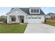 Charming single-Gathering home featuring a welcoming front porch and a two-car garage at 5365 Maggie Mae Ln, Cumming, GA 30028