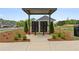 View of the community mailboxes in a landscaped area with a gazebo and homes in the background at 5365 Maggie Mae Ln, Cumming, GA 30028