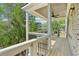 A covered back porch with wood flooring, black railings and a ceiling fan at 104 Cottage Gate Ln, Roswell, GA 30076