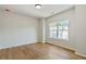 Minimalist bedroom with hardwood floors and plenty of natural light at 104 Cottage Gate Ln, Roswell, GA 30076