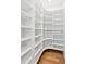 Walk-in closet with custom shelving and hardwood floors providing ample storage space at 104 Cottage Gate Ln, Roswell, GA 30076