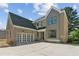 Beautiful brick home with a two-car garage and modern gray accents at 104 Cottage Gate Ln, Roswell, GA 30076