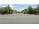 A street view of the new homes with mature trees and a beautiful community at 104 Cottage Gate Ln, Roswell, GA 30076