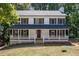 Two-story house with white siding,navy shutters, and a wraparound porch at 4166 Riverhill Ne Ct, Roswell, GA 30075