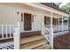 Charming front porch with white railings and wooden floors at 4166 Riverhill Ne Ct, Roswell, GA 30075