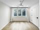 Bright bedroom featuring wood floors, three windows and a modern ceiling fan at 371 Pratt Se Dr # 203, Atlanta, GA 30315