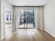 Bright living room featuring wood floors and sliding glass door with access to balcony at 371 Pratt Se Dr # 203, Atlanta, GA 30315
