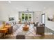 Bright living room with modern decor, including plush seating, stylish rug, and ample natural light at 371 Pratt Se Dr # 203, Atlanta, GA 30315