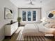 Cozy bedroom with a large bed, modern dresser, decorative pillows, and bright natural light at 371 Pratt Se Dr # 203, Atlanta, GA 30315
