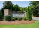Community entrance featuring a brick sign and manicured landscaping at 2539 Hedgeway Cir, Kennesaw, GA 30144