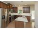 Bright kitchen featuring an island, stainless steel appliances, and warm wood floors at 2539 Hedgeway Cir, Kennesaw, GA 30144