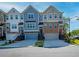 View of townhomes featuring unique colors, brick accents and garages at 2539 Hedgeway Cir, Kennesaw, GA 30144