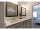 Bright bathroom featuring double sinks, large mirrors, modern fixtures, and bedroom doorway at 626 Skytop Dr # 159, Cumming, GA 30040