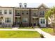 Well-maintained brick townhomes featuring inviting entryways, manicured lawns and sidewalk access at 626 Skytop Dr # 159, Cumming, GA 30040