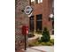 Red post office box outside brick building in a traditional British setting at 626 Skytop Dr # 159, Cumming, GA 30040