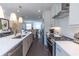 Gourmet kitchen with stainless steel appliances, island sink, and modern cabinetry at 626 Skytop Dr # 159, Cumming, GA 30040