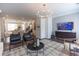 Open concept living room featuring modern light fixture, dark wood floors, and neutral colored decor at 626 Skytop Dr # 159, Cumming, GA 30040