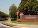 Beautiful community entrance with brick signage, manicured lawns, and colorful flowerbeds at 626 Skytop Dr # 159, Cumming, GA 30040