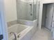 Bathroom featuring a separate tub and tiled shower at 629 Silva St # 128, Cumming, GA 30040