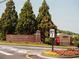 Entrance to The Collection at Forsyth, with brick signage and landscaped flowerbeds at 629 Silva St # 128, Cumming, GA 30040