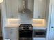 Modern kitchen featuring stainless steel appliances, white cabinets, and ample counter space at 629 Silva St # 128, Cumming, GA 30040