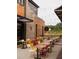 Vibrant outdoor dining area with colorful chairs and string lights overhead at 629 Silva St # 128, Cumming, GA 30040