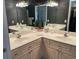 Double-sink vanity with ample counter space and mirrors with vanity lights above at 3334 Peachtree Ne Rd # 1110, Atlanta, GA 30326
