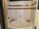 Cozy bathtub surrounded with decorative accents to create a warm bathroom at 3334 Peachtree Ne Rd # 1110, Atlanta, GA 30326
