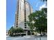 Upscale high-rise building featuring multiple balconies and well-maintained landscaping near a city street at 3334 Peachtree Ne Rd # 1110, Atlanta, GA 30326
