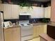 Bright kitchen features a white stove, white cabinets, and a neutral countertop at 3334 Peachtree Ne Rd # 1110, Atlanta, GA 30326
