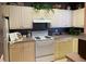 Bright kitchen features a white stove, white cabinets, and a neutral countertop at 3334 Peachtree Ne Rd # 1110, Atlanta, GA 30326