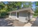 A gray brick home exterior with a wooden deck surrounded by green trees and shrubbery at 2121 Arlington Ne Ave, Atlanta, GA 30324